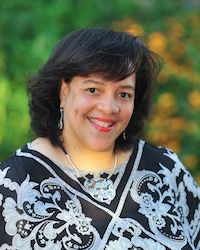 A woman poses for a portrait outdoors