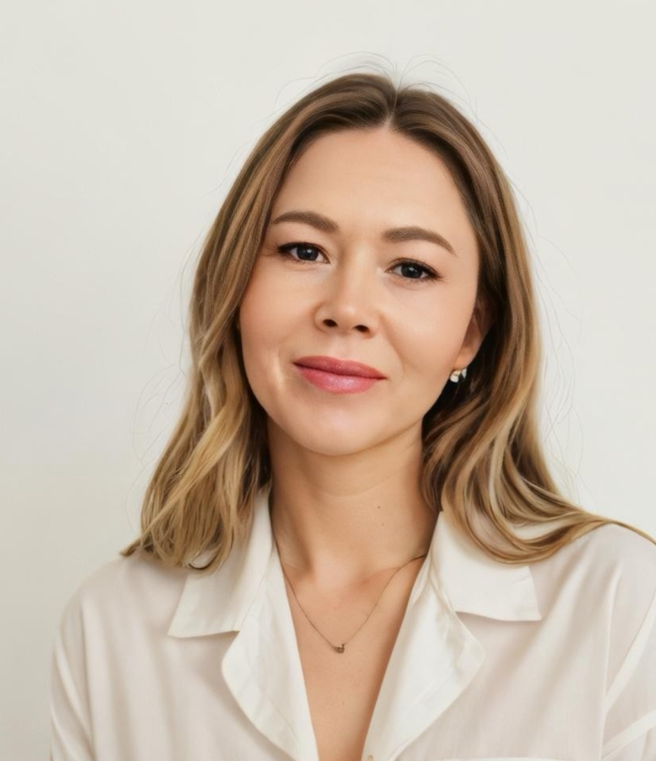 A headshot of a woman against a light background