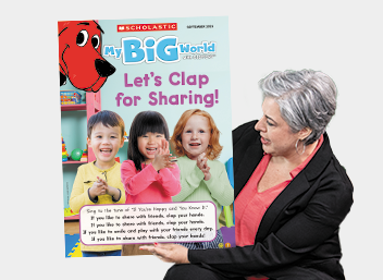 A person holds a copy of My Big World magazine with the headline Let's Clap for Sharing