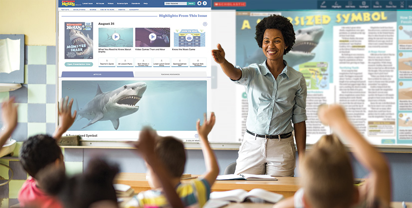 A woman leads a classroom lesson as students raise their hands toward a digital whiteboard