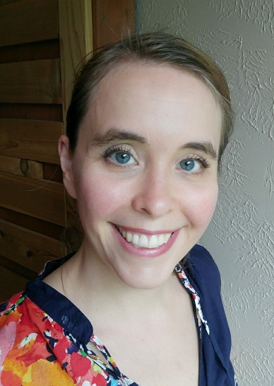 A woman faces the camera in a close portrait shot outdoors